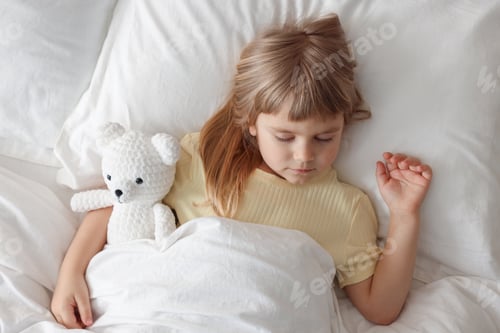 Preview: Bedtime. Cute little girl sleeping with toy bear in bed, above view