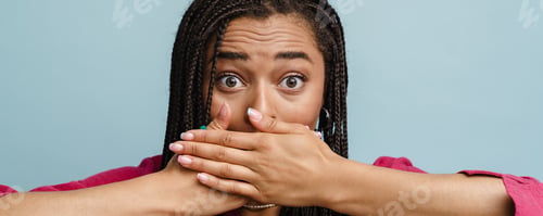 Preview: Young black shocked woman with pigtails covering her mouth