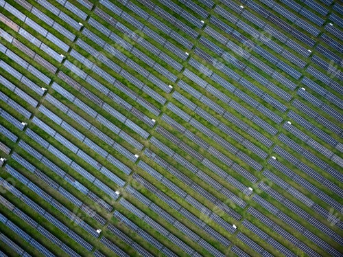 Preview: Aerial drone view of solar power plant in green meadow at sunny day.