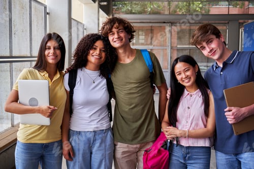 Preview: Portrait of a multiracial group of school students looking at camera smiling, gathered after class.