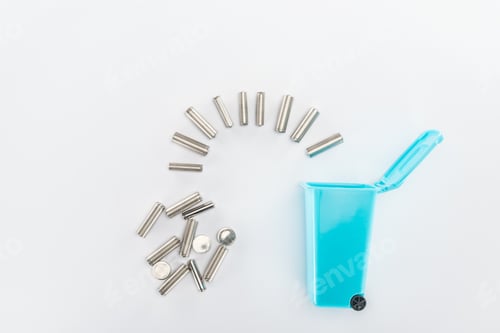 Preview: Blue toy trashcan and batteries on grey background