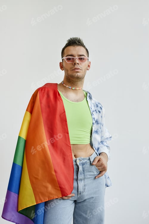 Preview: Young gay man draped with pride flag