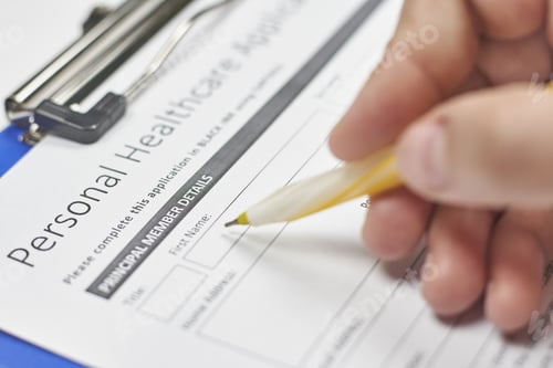 Preview: Hand of a person filling in a healthcare insurance application