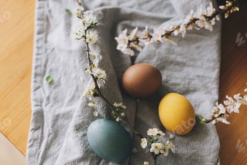 Preview: Happy Easter! Easter eggs on rustic table with cherry blossoms