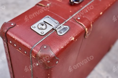 Preview: Part of vintage retro suitcase. Closeup view of lock on old suit case