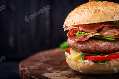 Preview: Big sandwich - hamburger burger with beef, cheese, tomato, cucumber and fried bacon.