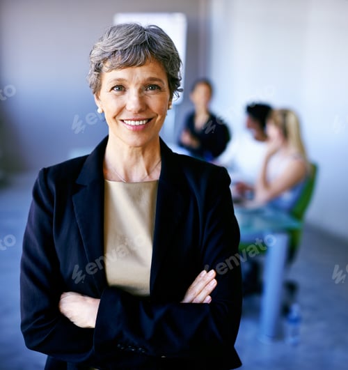 Preview: Portrait of a businesswoman standing in front of her colleagues during a meeting