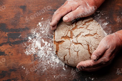 Preview: Baker holding fresh baked homemade bread