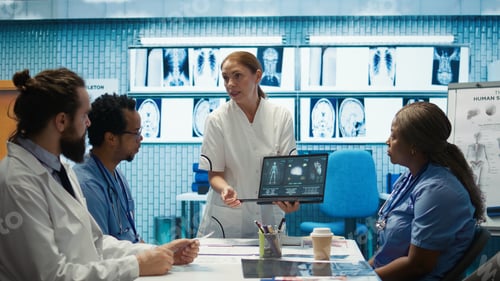 Preview: Diverse medical team examining test results and discussing innovative treatment plans