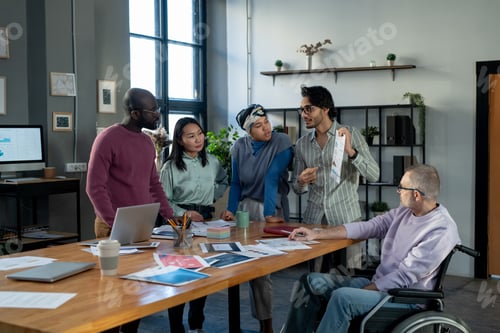 Preview: Group of contemporary economists listening to confident male colleague