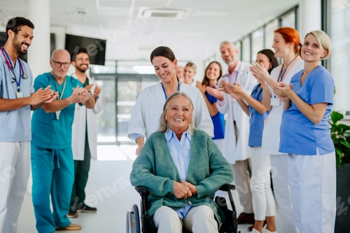 Preview: Medical staff clapping to senior patient who recovered from serious illness.