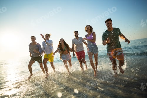 Preview: Friends running on shore at beach