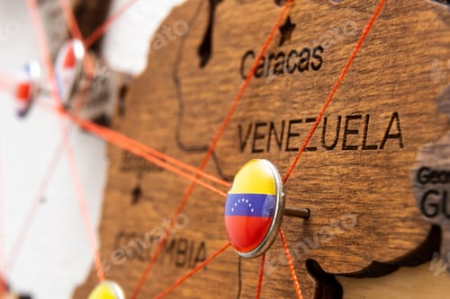 Preview: Venezuela flag pins and red thread for traveling and planning trip.