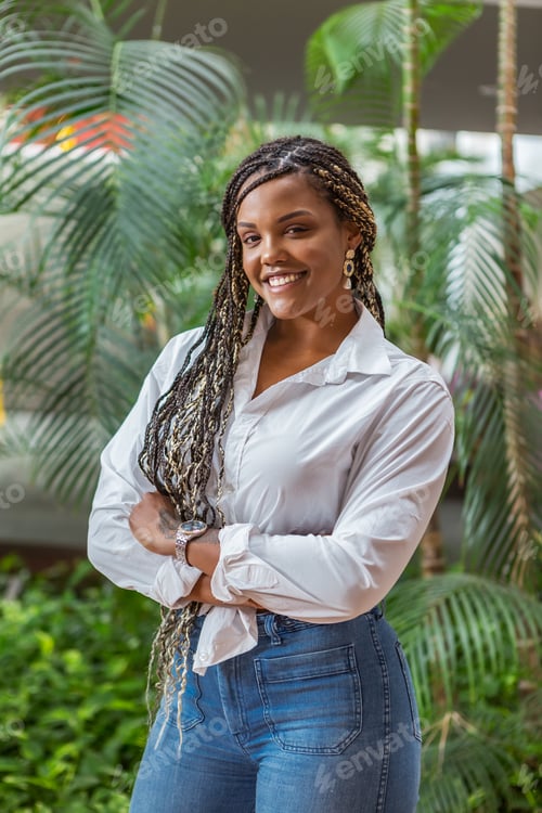 Preview: African American adult woman standing with her arms crossed and looking at the camera