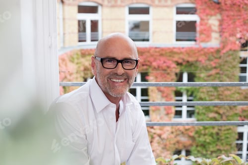 Preview: Portrait of smiling man at the window
