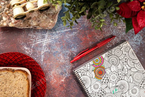 Preview: Top view of an old rusty metal desk texture with binoculars on a stone base, notebook and a toast