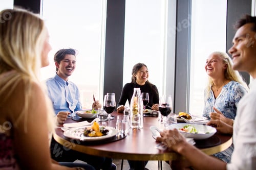 Preview: Smiling friend enjoying meal at Sky bar restaurant