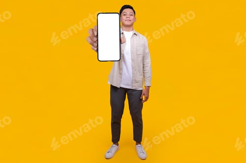 Preview: Young Man Showing Blank Smartphone Screen.