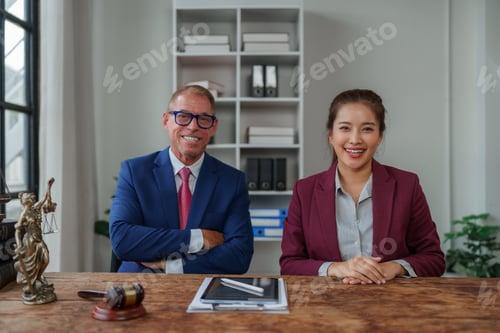 Preview: Legal professionals sitting at office desk smiling
