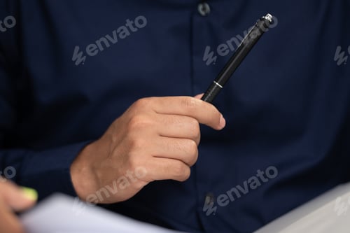 Preview: business man using a pen to sign a agreement document paper to approve by signature