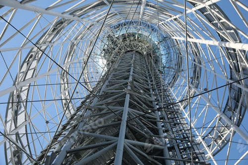 Preview: Structure of modern tower against blue sky, bottom view