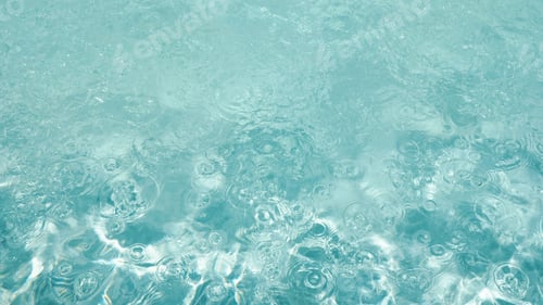 Preview: Abstract water background with ripples. Light caustics effect.