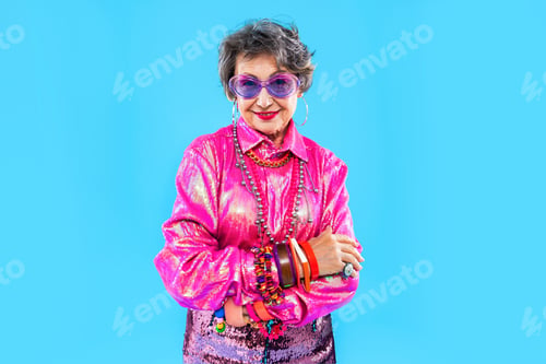 Preview: Happy and funny senior old woman on colorful background