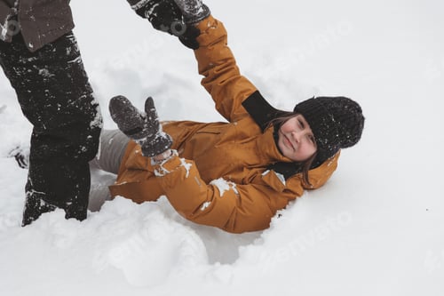 Preview: Dad and daughter play snowballs in the yard, Family Having Fun Outdoors At Winter