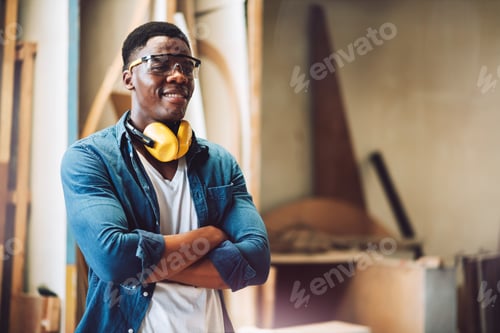 Preview: Young adult men carpenter craftman working in small business wood workshop