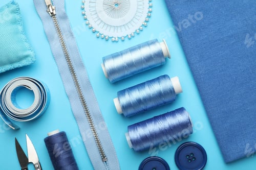 Preview: Different sewing supplies on light blue background, flat lay
