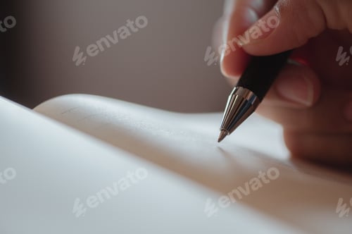Preview: Female hand close-up writes with a pen in a blank notebook.she writing a daily lifetime.Business wom