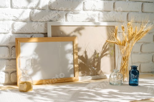 Preview: Photo frames on a brick wall background on the table with wheat ears in vase