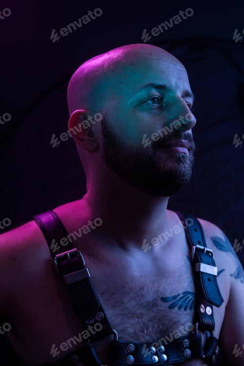 Preview: One Young Man, Shirtless Colorful Portrait, Wearing A Harness. Upper Body Shot, Looking Sideways.