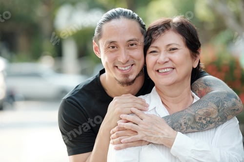 Preview: Happy family standing outdoors
