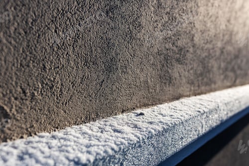 Closeup of Snow on the side of building