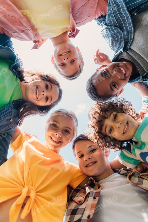 Preview: bottom view of cheerful multicultural kids looking at camera