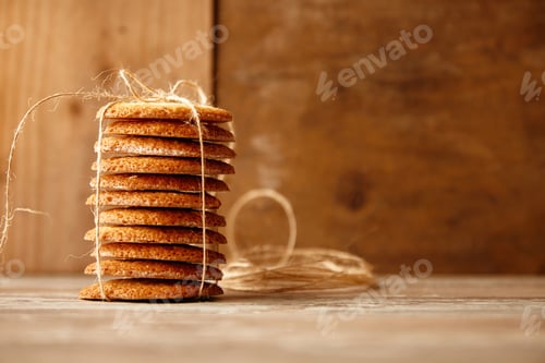 Preview: Stack of cookies tied with craft rope on wooden table
