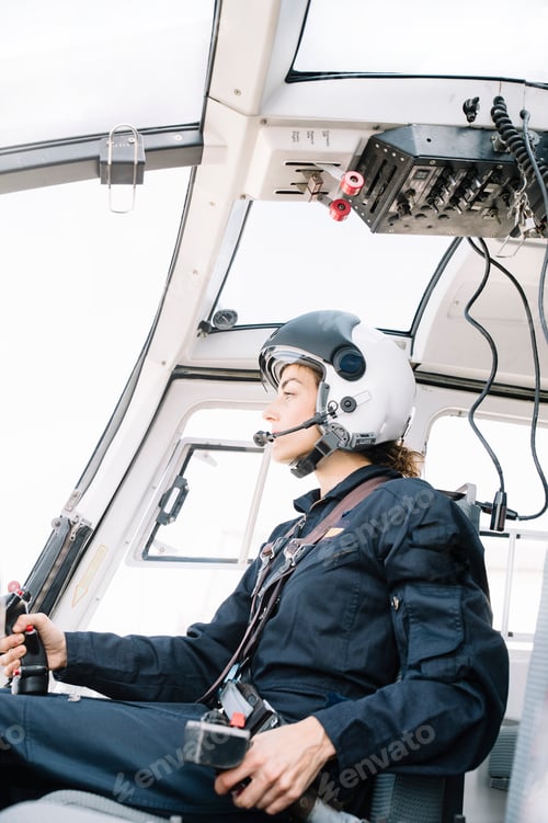 Preview: Attractive woman pilot sitting in the helicopter