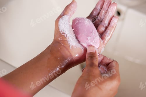 Preview: young man washing hands with soap warm water