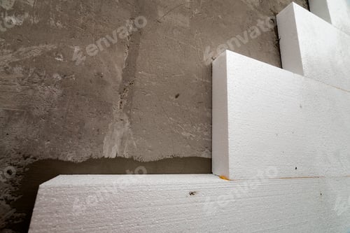 Preview: Close-up detail of plastered house wall with rigid styrofoam insulation.