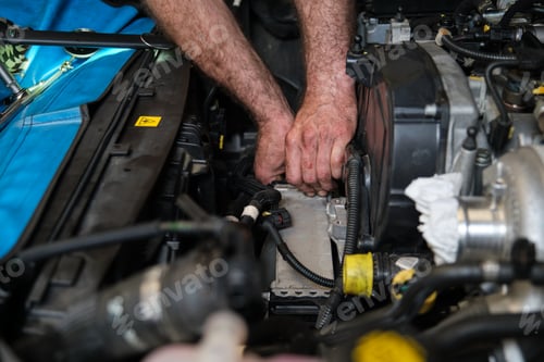 Preview: Car mechanic hands replacing intercooler on a car engine.