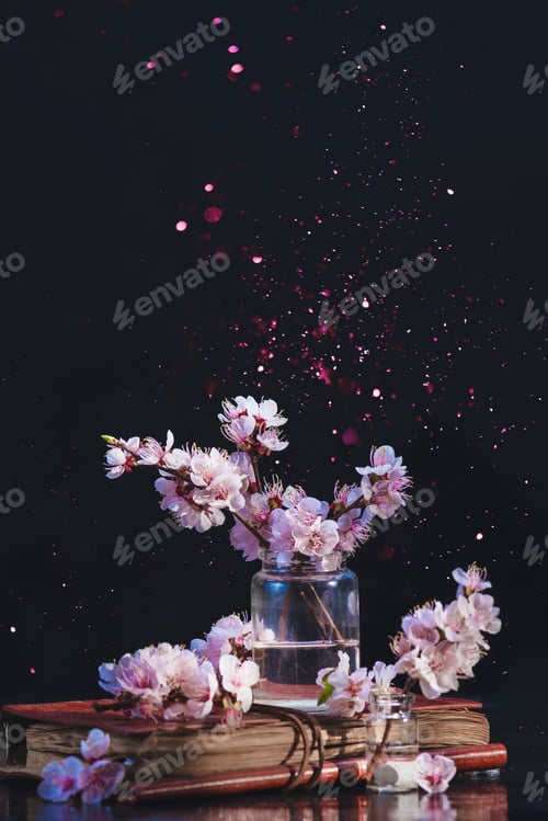 Preview: Spring cherry blossom in a glass jar on a dark background with pink sparkle. Creative flower