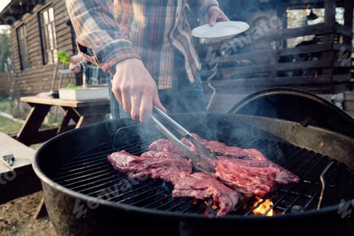 Preview: Man frying meat outdoors