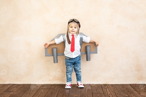 Preview: Child Pretending to Fly in Cardboard Airplane