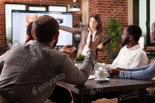 Preview: Executive manager discussing project ideas pointing at monitor