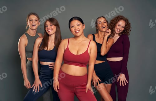 Preview: Group of five young women in sports clothes in studio shot
