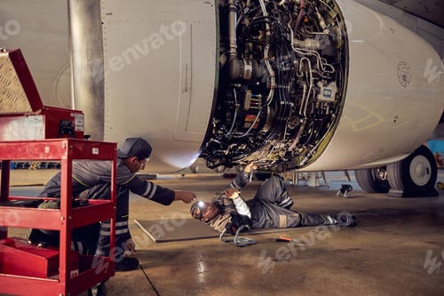 Preview: Two mechanics is working with civil airplane