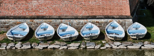 Preview: SIX WHITE BOATS ON THE RIVER BANK BY THE BRICK WALL