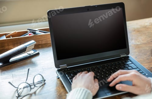 Preview: Blank screen laptop computer, home office work. Man type, open notebook on desk, copy space
