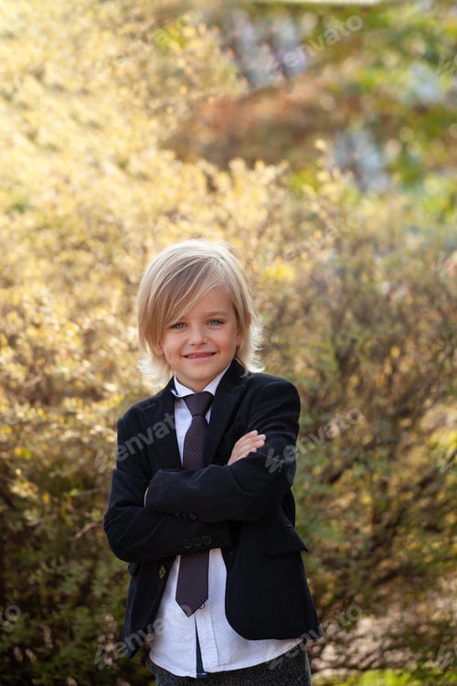 Preview: Outdoor portrait of Fashionable Schoolboy with school uniform, blonde boy.